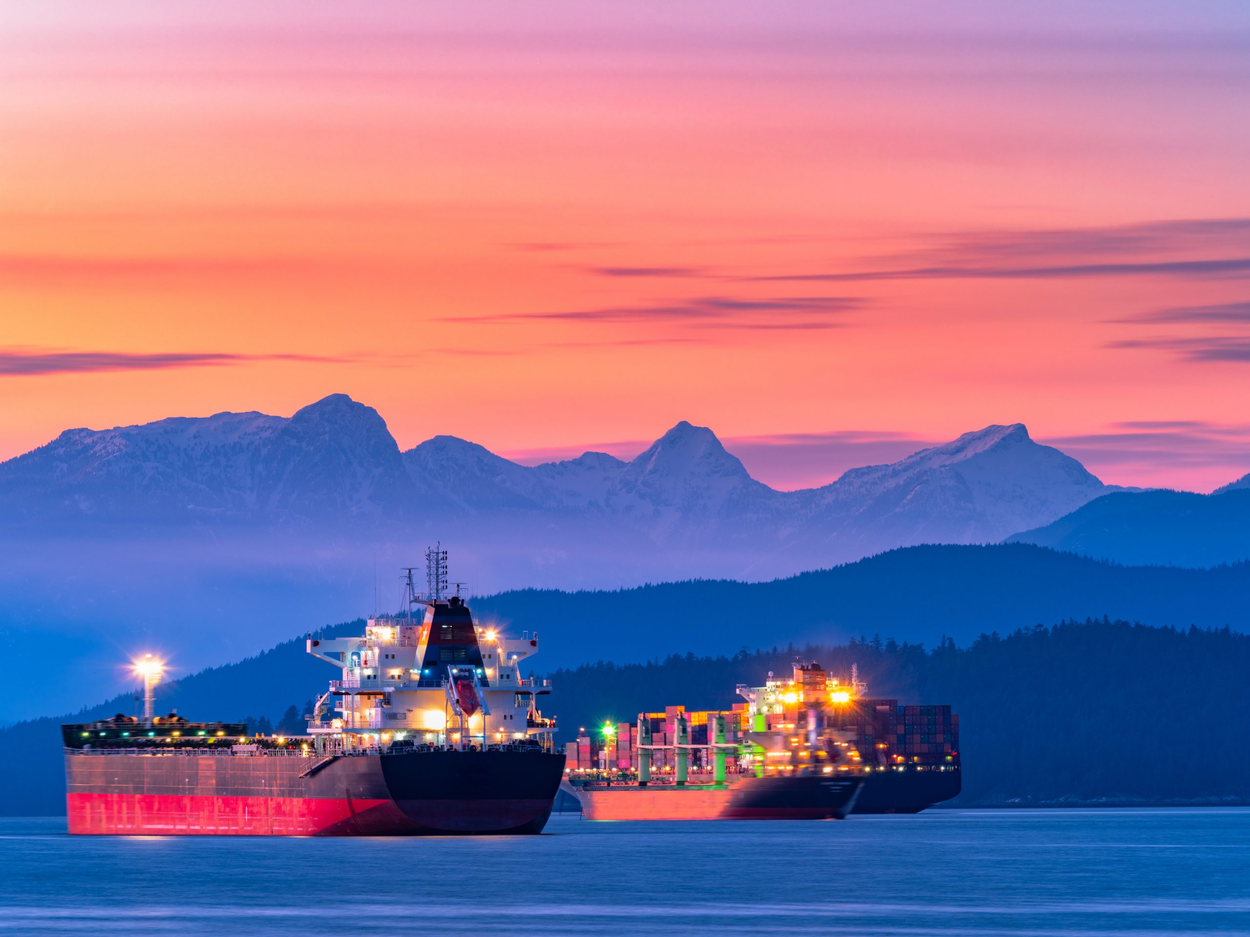 freighters stop at the bay of vancouver at sunset.
